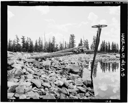 HAER photo showing upright outlet gate wheel, stem and stem guide, with log access structure, looking southest, July 1985