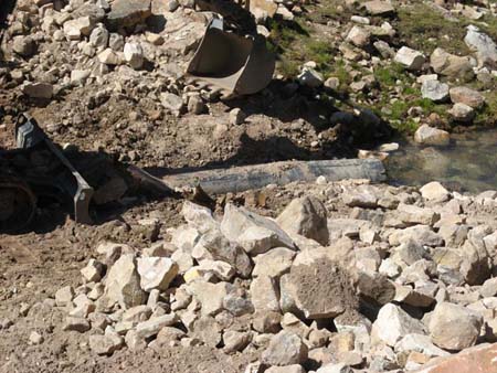 07-Drift Lake Stabilization, crew uses trackhoe to remove outlet pipe