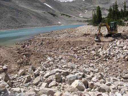 09-Drift Lake Stabilization, placing riprap along sides of new outlet channel