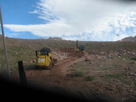 04-East Timothy Stabilization, trackhoes and skidsteers excavate breach in dam