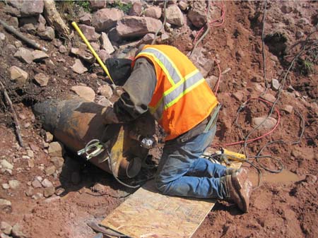 22-East Timothy Stabilization, welding steel plate on downstream end of pipe