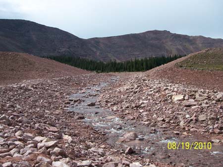 26-East Timothy Stabilization, looking upstream to completed breach with water flowing through