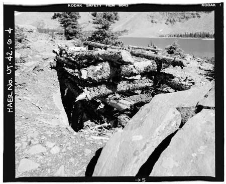 HAER photo of cribbed log structure over Farmers Lake Tunnel air hole and outlet valve, looking north, July 1985