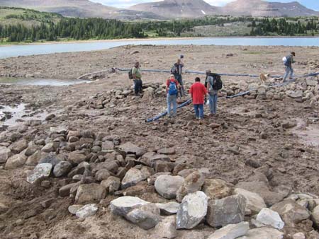 19-Five Point Lake Stabilization, hand crew washing fines into new outlet channel to fill voids