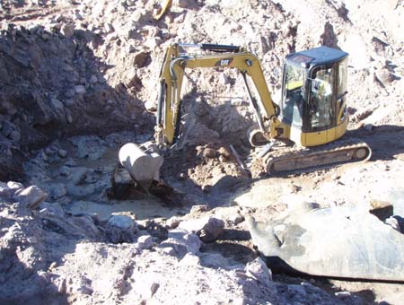 12-Kidney Lake Stabilization, demolition of inlet structure using trackhoe