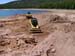 04-Kidney Lake Stabilization, skid steer begins cutting breach through dam