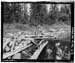 HAER photo of upstream face of Water Lily Lake Dam with upright inoperable outlet gate, looking west, July 1985